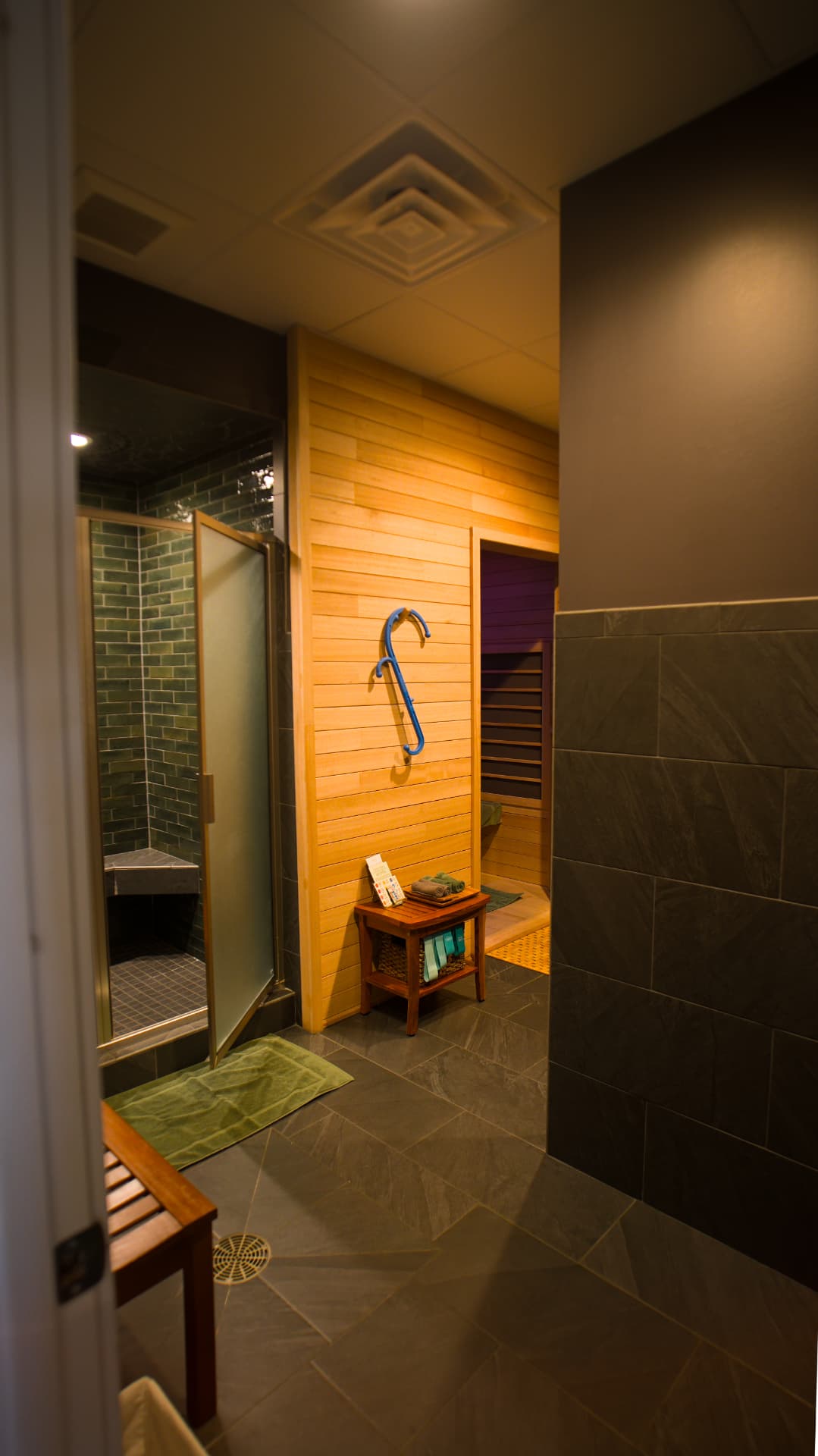 Contrast suite hallway with cedar infrared sauna and glass-door cold shower