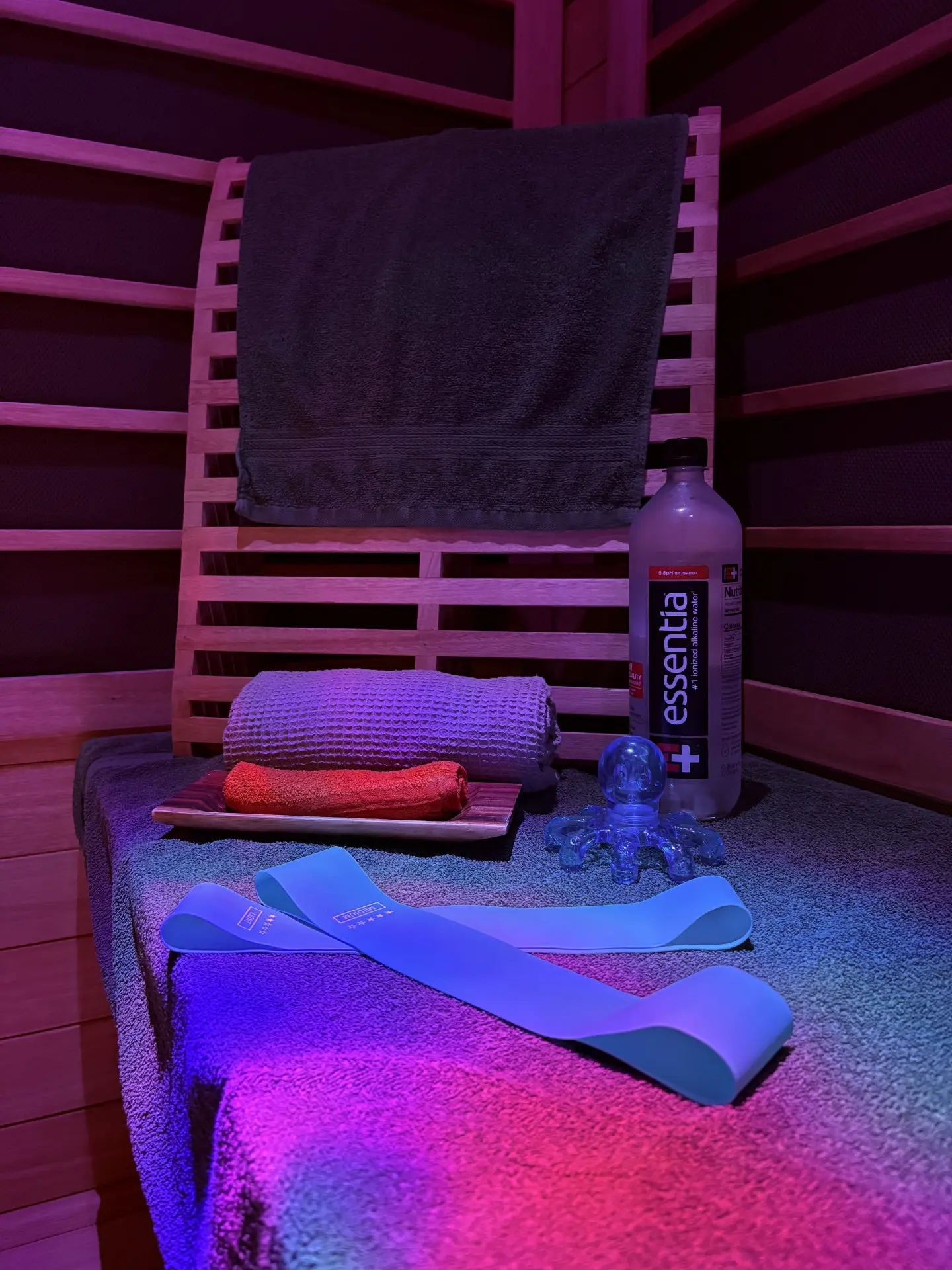 Sunlighten infrared sauna bench set with towels, Essentia water, resistance bands and a muscle roller